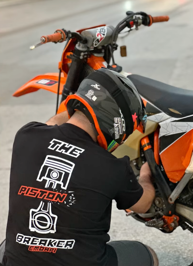 Siyah The Piston Breaker baskılı motorcu tişört giymiş motorcu